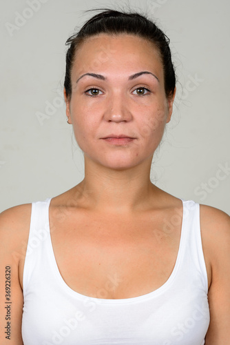 Portrait of beautiful woman against white background