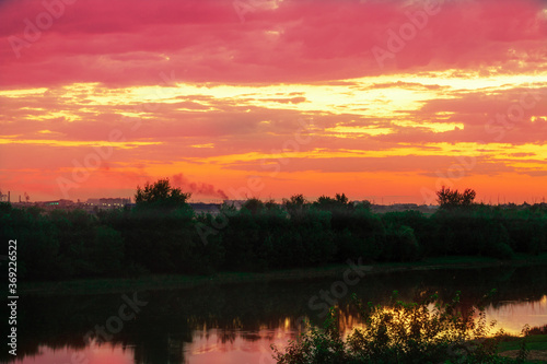 beautiful river Bank under a cloudy sky at sunset © Ильнур Губайдулин