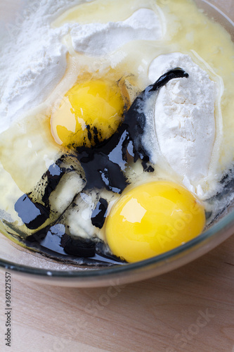 Pasta ingredients: flour, eggs and squid ink photo