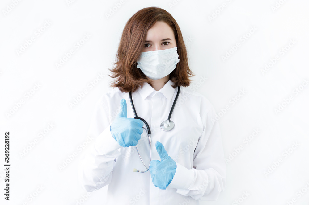 Smart young asian woman doctor in lab coat with Medical face mask,white latex medical gloves and stethoscope against blue background,health care concept Smart young asian woman doctor in lab coat with Medical face mask,white latex medical gloves and stethoscope against blue background,health care concept
