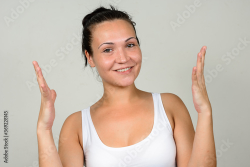 Portrait of happy beautiful woman against white background