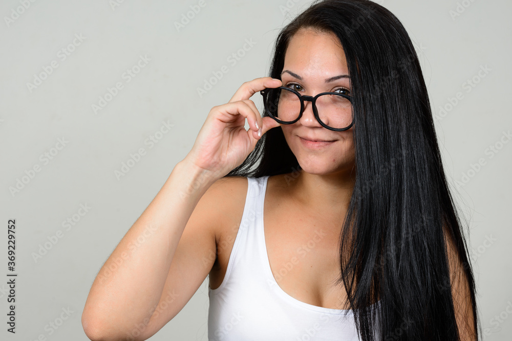 Portrait of beautiful woman with eyeglasses against white background Portrait of beautiful woman with eyeglasses against white background