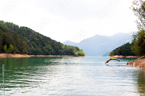 Man diving into the lake. Mountain vacation concept. Lake and nature. © DALU11