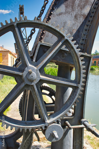 Polea y rueda dentada de antigua grua en la darsena del Canal de Castilla en Valladolid photo