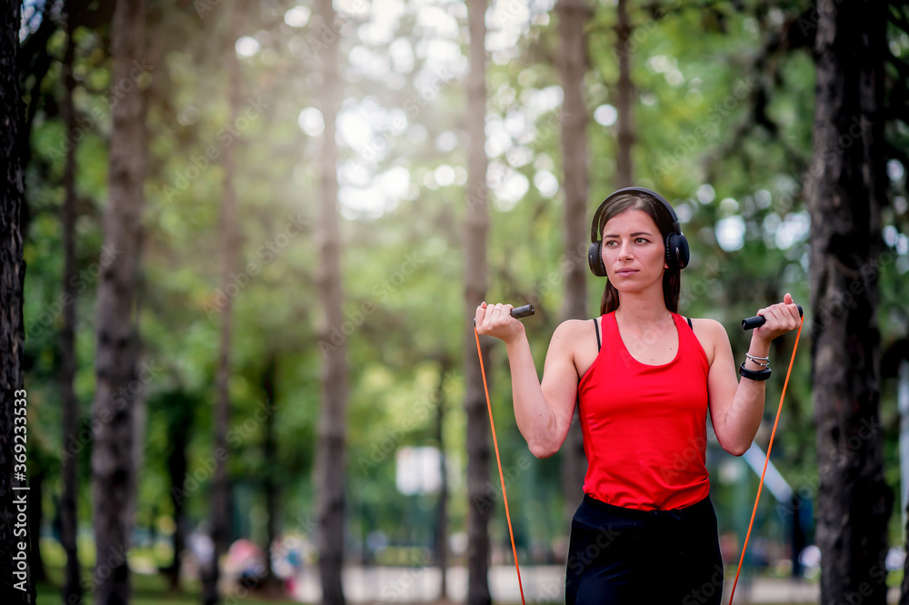 Woman exercising with jumping rope outdoors Woman exercising with jumping rope outdoors