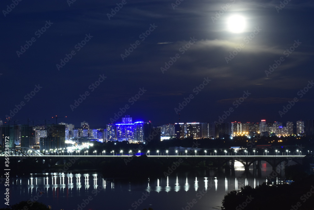 Night cityscape with moon. Residential district of Kyiv, Ukraine.