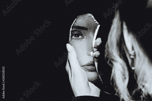 Black and white portrait of woman and broken self-image mirror