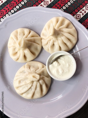 Delicious khinkali with meat and sour cream