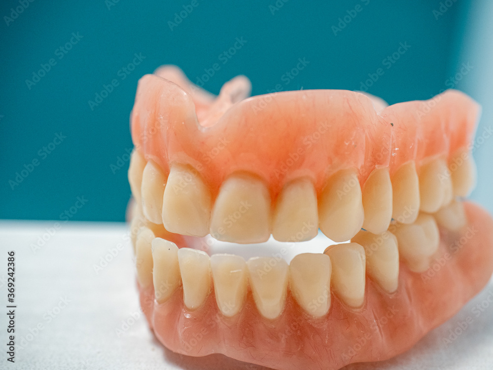 DENTURES ON BLUE AND WHITE BACKGROUND WITH COPY-SPACE DENTURES ON BLUE AND WHITE BACKGROUND WITH COPY-SPACE