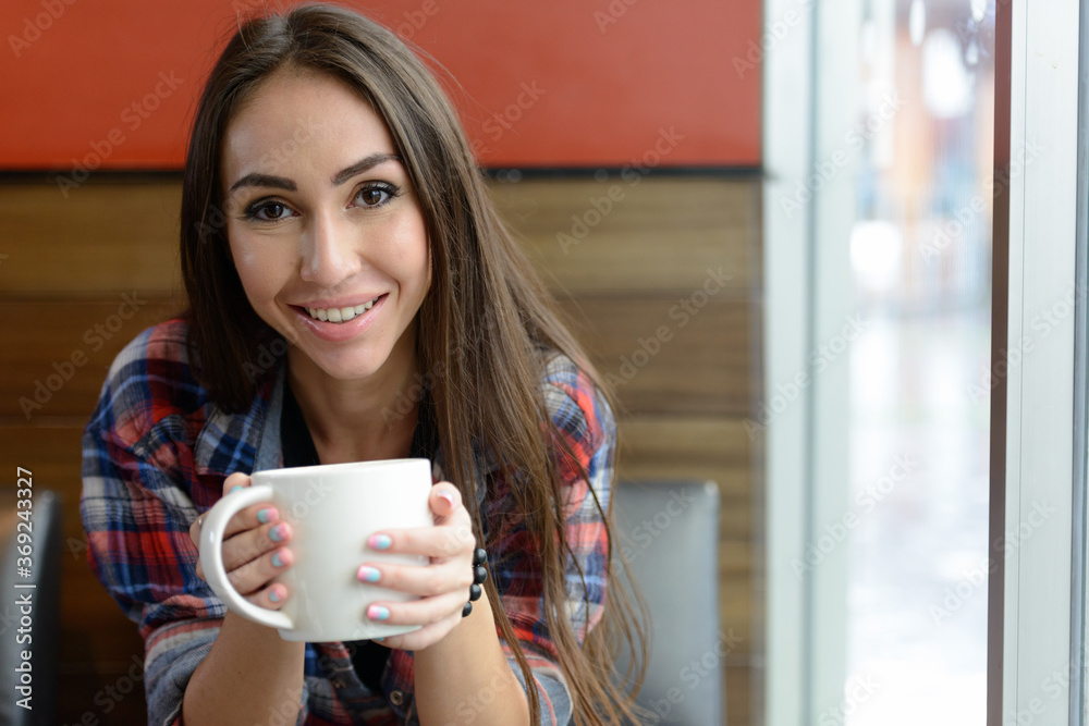 Portrait of young beautiful hipster woman at the coffee shop Portrait of young beautiful hipster woman at the coffee shop
