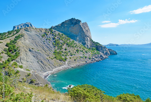 View of a high cliff and a turquoise sea in summer