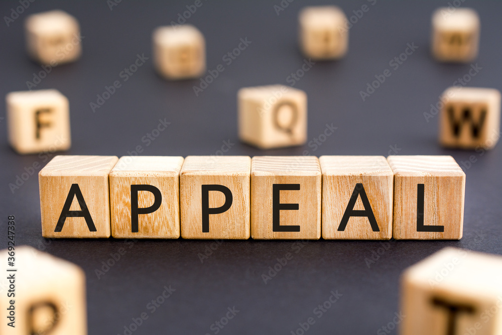 Fototapeta premium Appeal - word from wooden blocks with letters, urgent request appeal concept, random letters around white background
