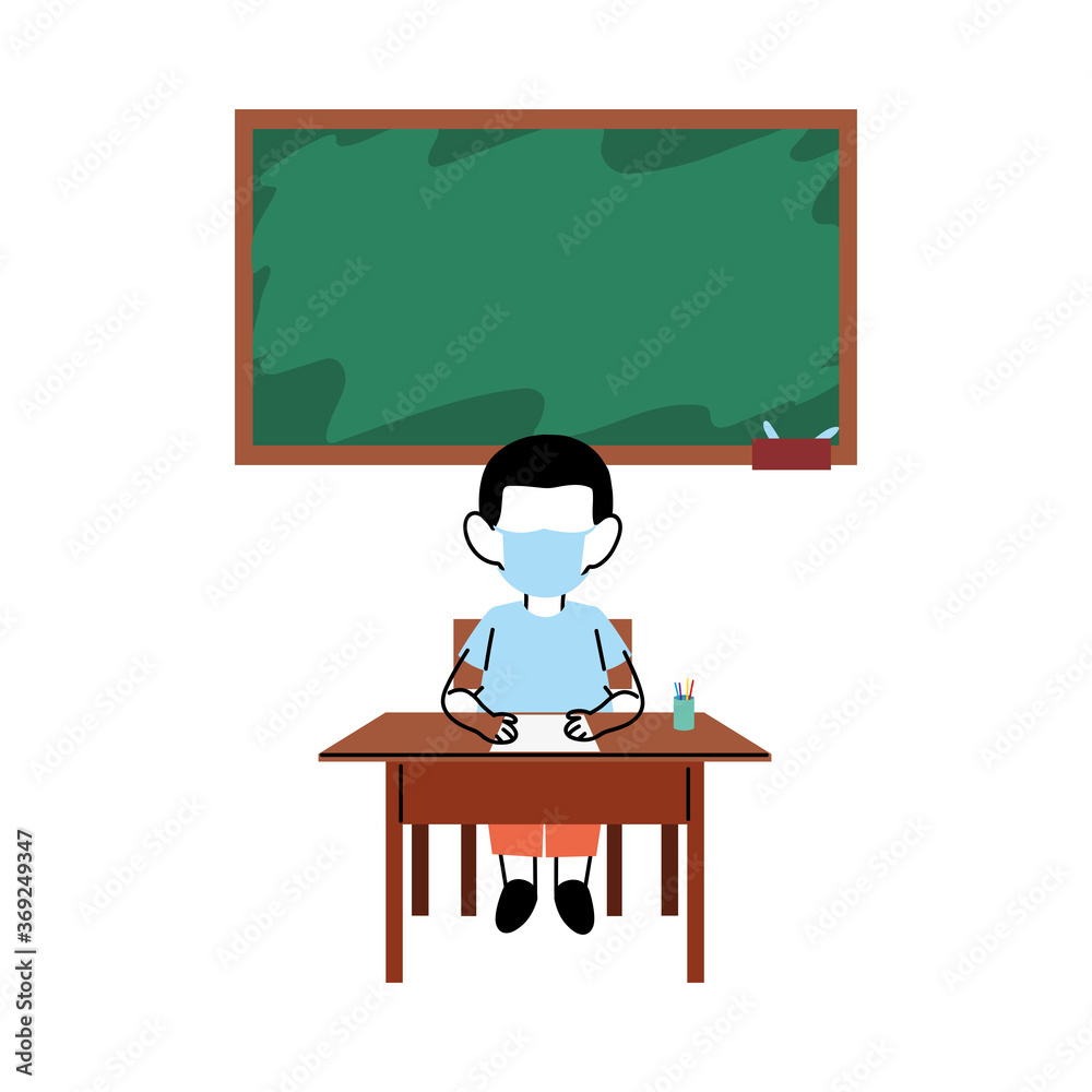 Boy with mask on desk in classroom Boy with mask on desk in classroom