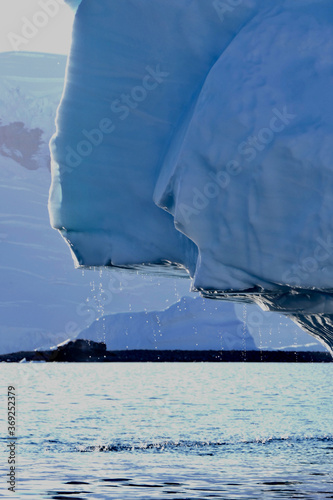 Melting iceberg, falling water drops, antarctic ocean, melting ice, Antarctica