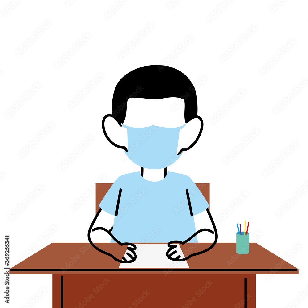 boy with face mask at school desk