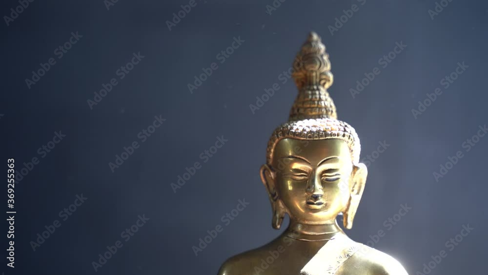 golden Idol face of buddha mediating with dark background golden Idol face of buddha mediating with dark background
