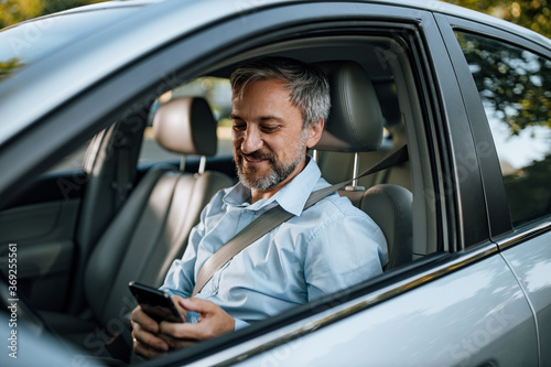 Man using phone while sitting in the car. © bnenin
