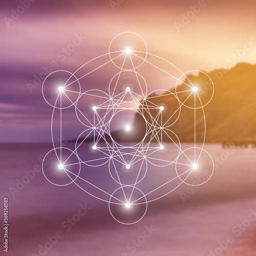 Merkaba sacred geometry spiritual new age futuristic illustration with interlocking circles, triangles and glowing particles in front of blurry natural photographic background