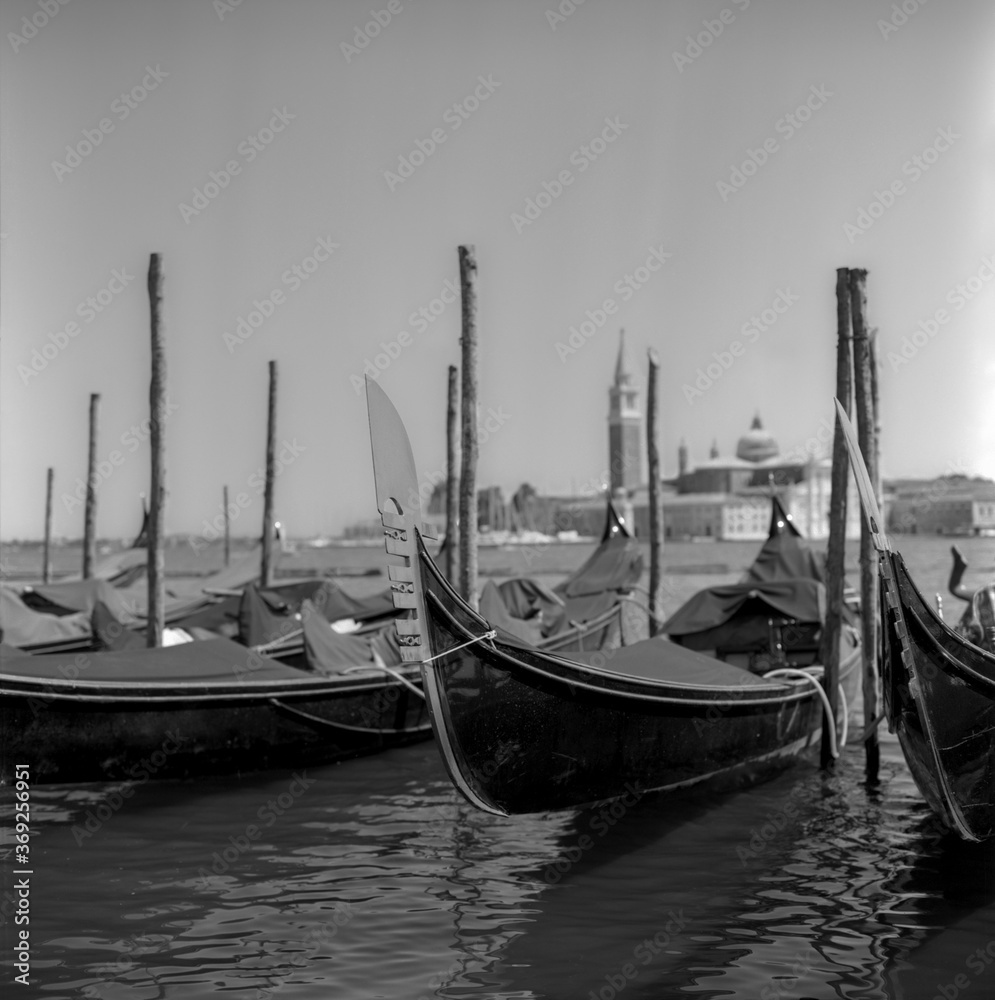 Gondolas in the morning in Venice shot with black and white analogue film technique