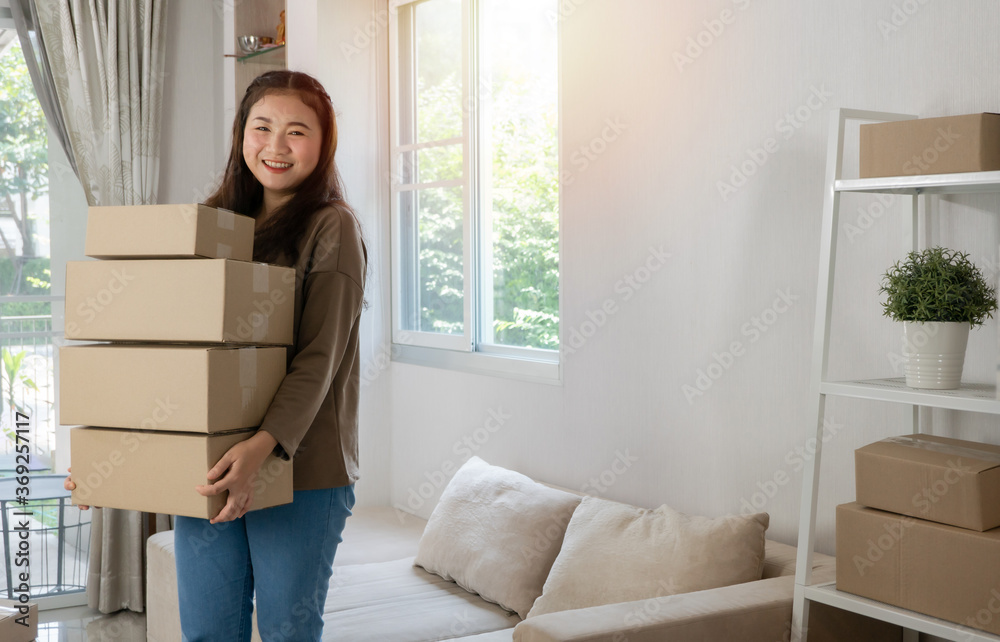 Happy young asian entrepreneurs are arranging boxes for delivering products to customers. Small business owner and success in online business concepts. Happy young asian entrepreneurs are arranging boxes for delivering products to customers. Small business owner and success in online business concepts.