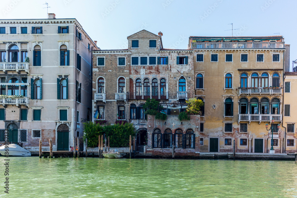 Naklejka premium The entrances on the water channels of the old palaces in Venice, as seen from a gondola