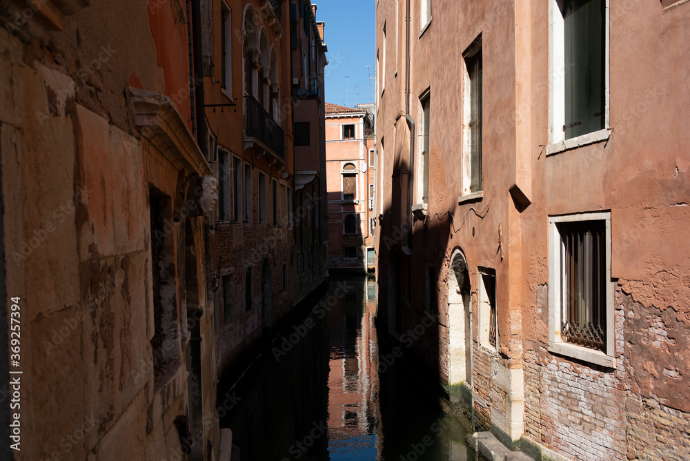 View of the  water channels, bridges and old palaces in Venice at sunrise during the lockdown