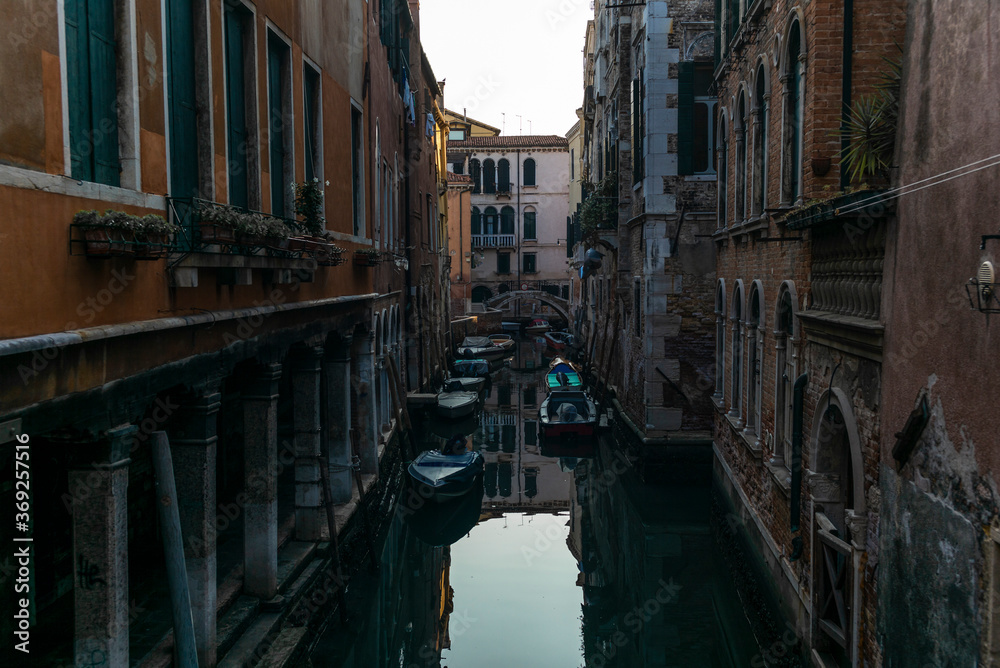 View of the  water channels, bridges and old palaces in Venice at sunrise during the lockdown