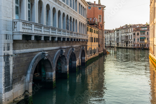 View of the water channels, bridges and old palaces in Venice at sunrise during the lockdown