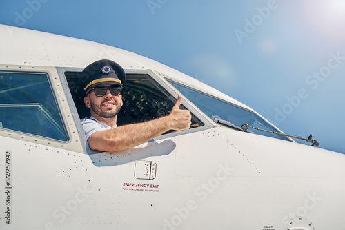 Fototapeta Smiling airman demonstrating his readiness for flight