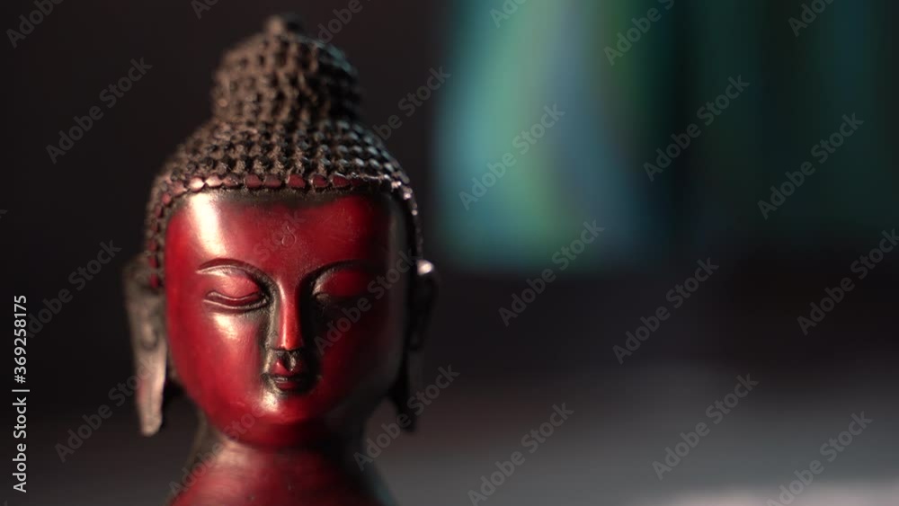 buddha red Idol face mediating with dark background buddha red Idol face mediating with dark background