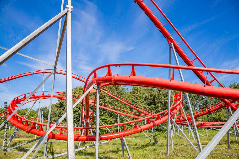 Roller coaster in an amusement park on a blue sky background on a sunny summer day