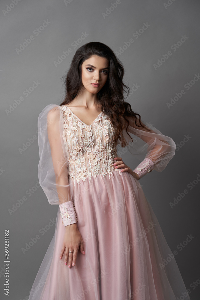Beautiful bride on gray background. Portrait of a Bride in beautiful wedding dress. Beautiful bride on gray background. Portrait of a Bride in beautiful wedding dress.