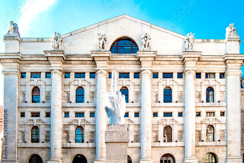 Facade of Palazzo Mezzanotte (in English: Midnight Palace), headquarters of the Italian Stock Exchange, in Piazza degli Affari, with the provocative contemporary sculpture LOVE by Maurizio Cattelan. photo