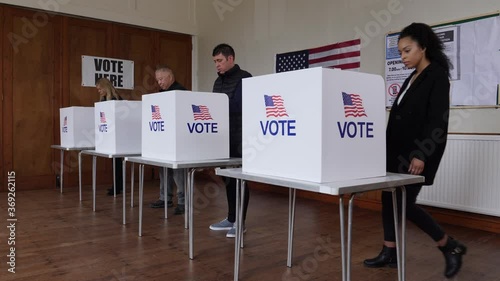 4K: Voters voting at Polling Place for USA Election.  People Stood at booths wearing Face Masks. Gimbal movement Up. Stock Video Clip Footage