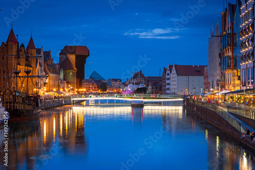Amazing architecture of Gdansk old town at night with a new footbridge over the Motlawa River. Poland