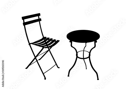Shadow of a wrought iron garden table and chair