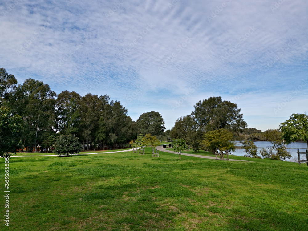 Beautiful panoramic view of a park with green grass, tall trees and paved trail for walking and cycling, Reid Park, Parramatta Cycleway, Rydalmere, Sydney, New South Wales, Australia
Beautiful panoramic view of a park with green grass, tall trees and paved trail for walking and cycling, Reid Park, Parramatta Cycleway, Rydalmere, Sydney, New South Wales, Australia