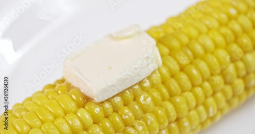 sweet farmhouse boiled corn and butter melt on it. close-up, studio shooting with macro lens