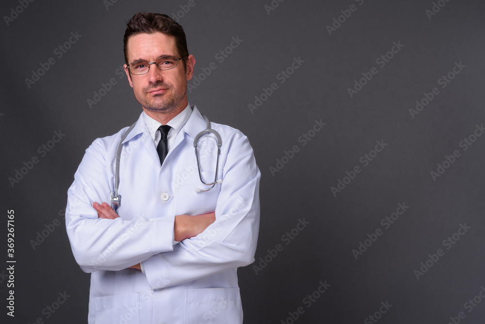 Portrait of handsome bearded man doctor against gray background Portrait of handsome bearded man doctor against gray background