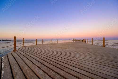 Wooden Pier on Red Sea in Hurghada at sunset and luxury yacht  View of the promenade boardwalk - Egypt  Africa