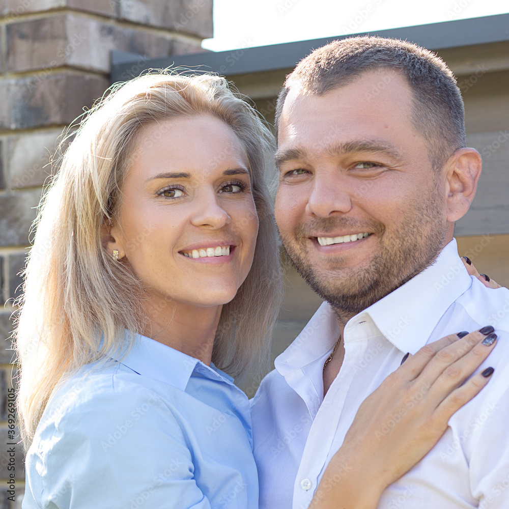 Beautiful fashionable modern couple man 45 years old woman 40 years hug, looking into frame. Great characters for advertising bank, dentistry, insurance, articles about psychology of family relations