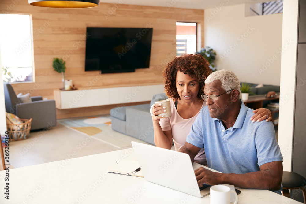 Senior African American Couple Using Laptop To Check Finances At Home Senior African American Couple Using Laptop To Check Finances At Home