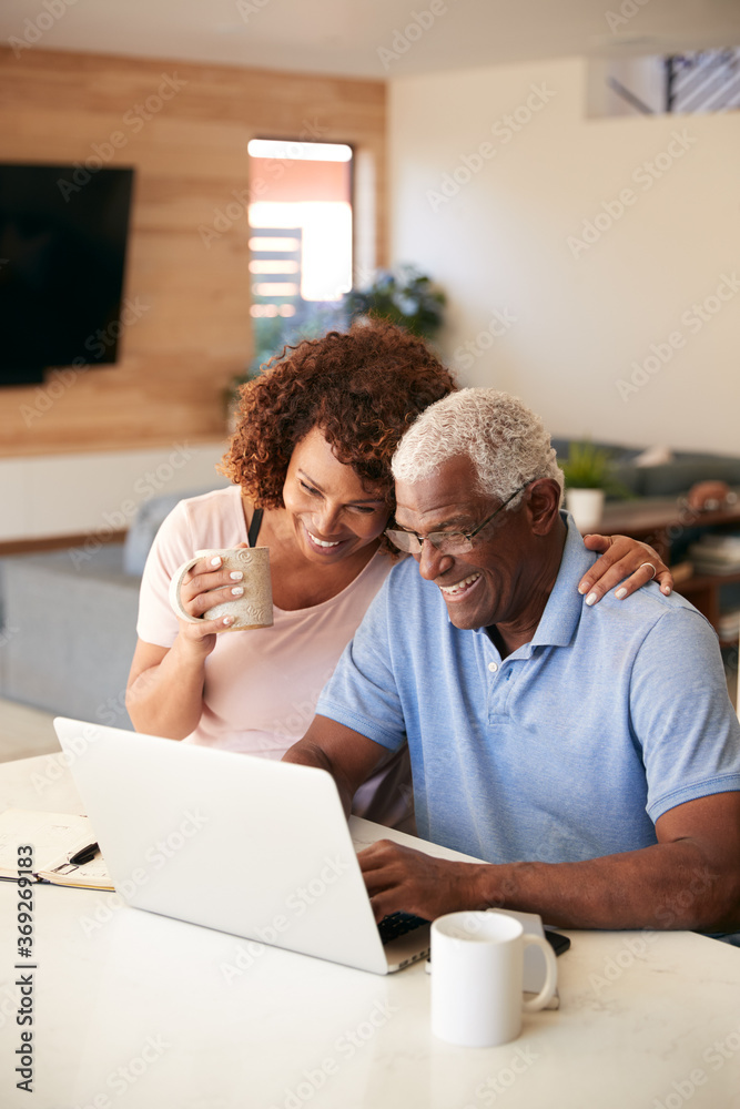 Senior African American Couple Using Laptop To Check Finances At Home Senior African American Couple Using Laptop To Check Finances At Home