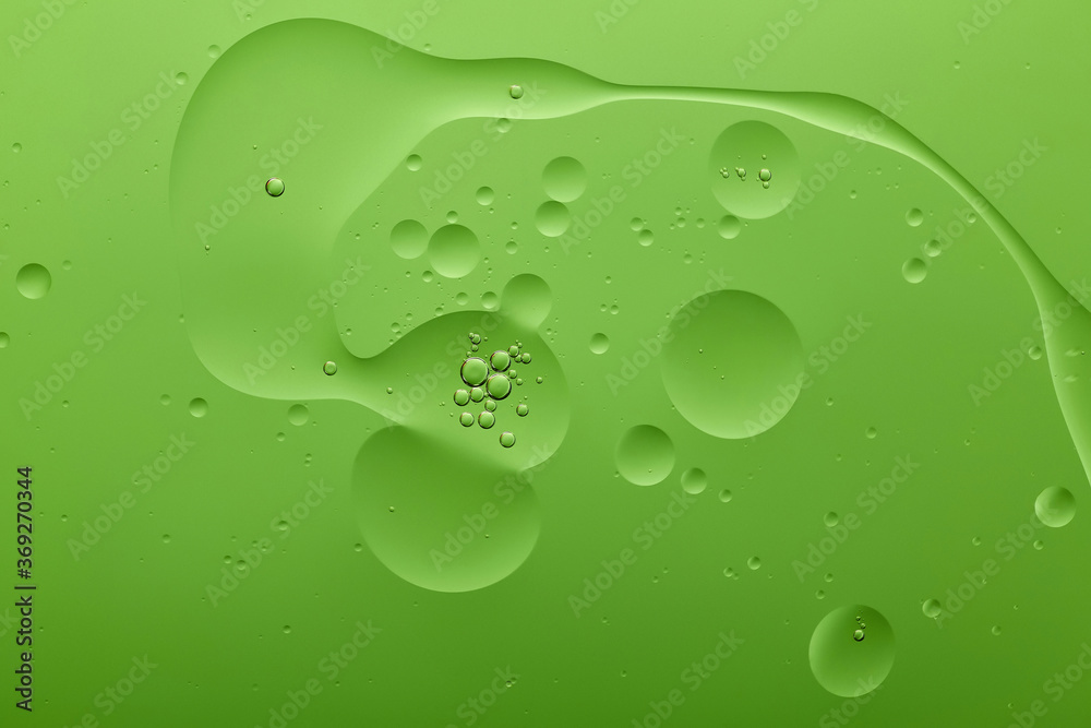 Current collection of brilliant backgrounds for your design. Close-up shot of silver bubbles in water spots on green surface.