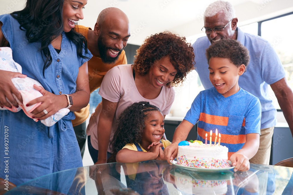 Obraz premium Multi-Generation African American Family Celebrating Daughters Birthday At Home Together
