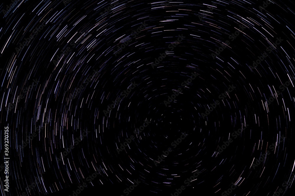 Circular star light trails. Starry background. Night sky rotation. Deep space concept. Circular star light trails. Starry background. Night sky rotation. Deep space concept.