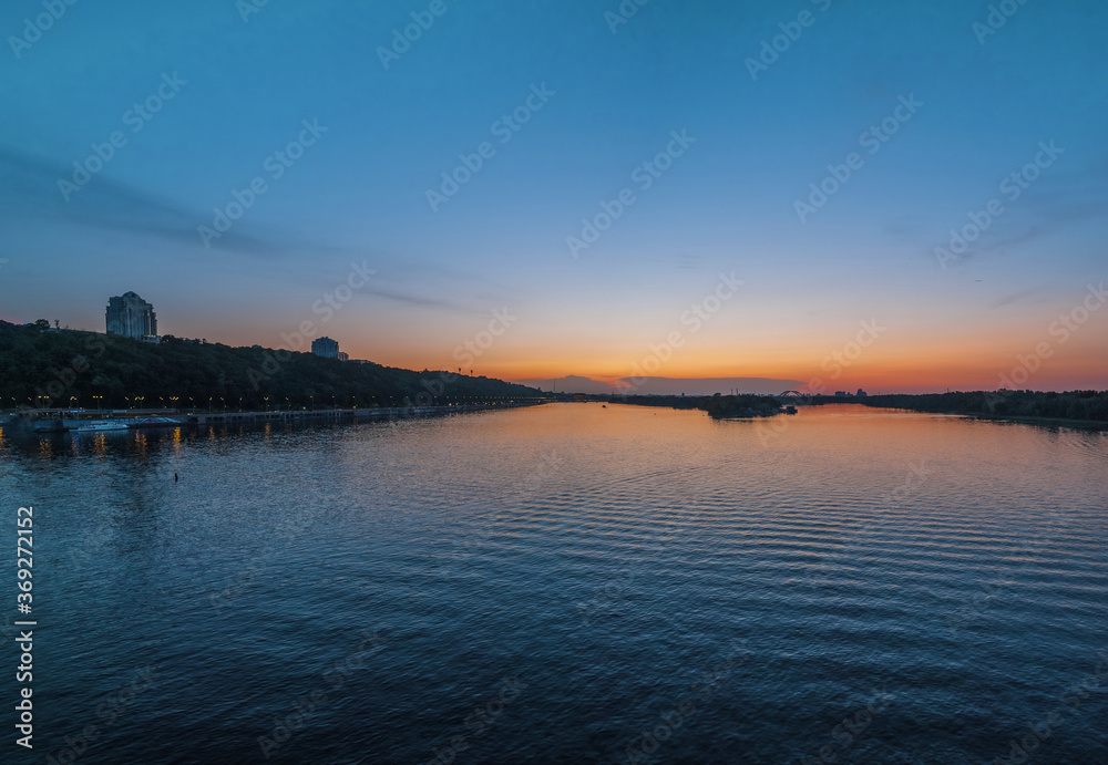 View of Trukhanov Island and the right bank of the Dnipro river and the embankment at sunset. Kyiv, Ukraine