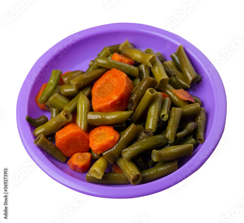 green beans with garlicand carrots on a plate isolated on white background.green beans with carrot top view. healthy food photo