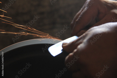 Obraz na płótnie Sparks grinding wheel while knife sharpening