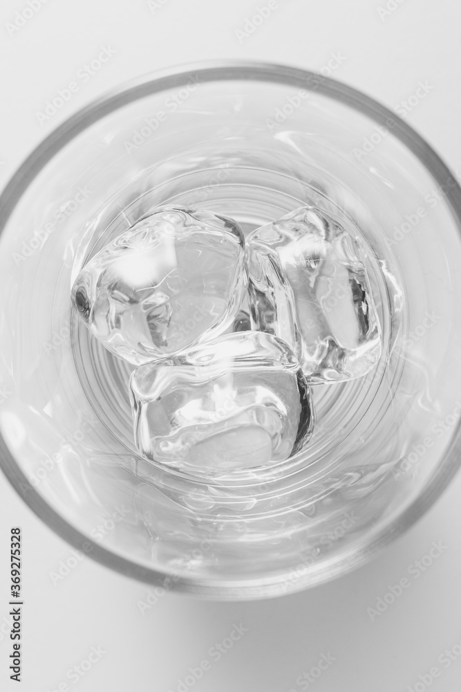 Top view of glass filled with ice cubes on white background